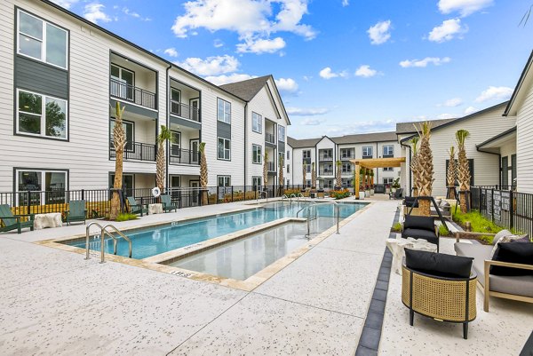 Rooftop pool with panoramic city views at Asher Apartments luxury complex