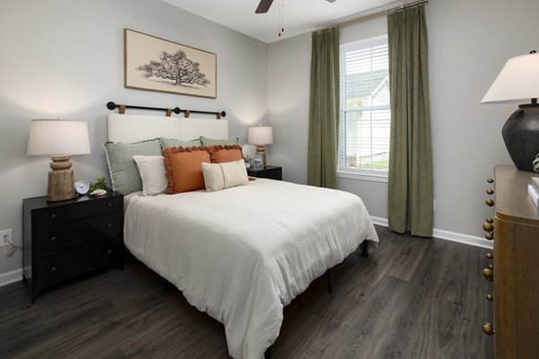 Comfortable bedroom with large windows at The Mill at White House Apartments