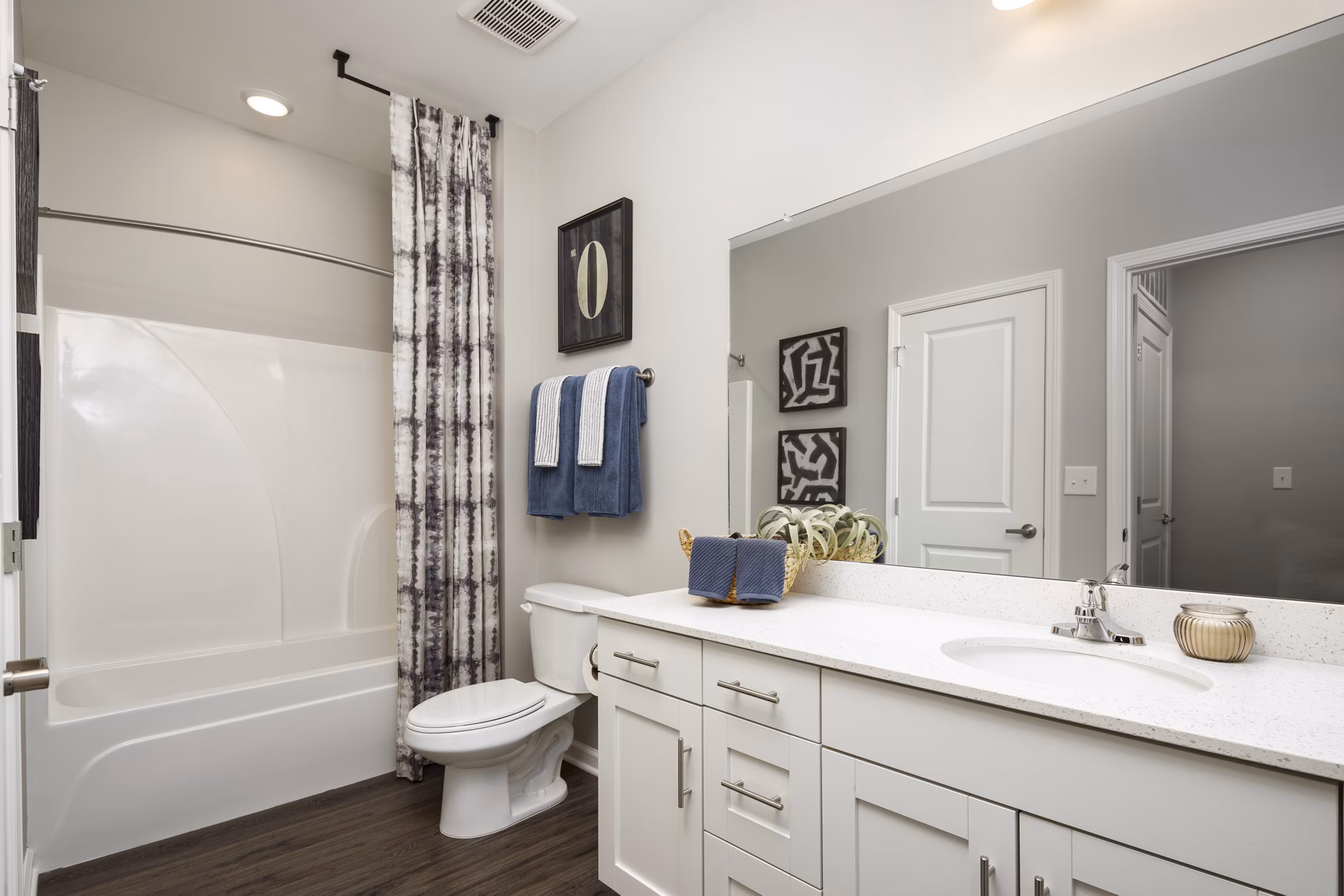Modern bathroom with sleek fixtures and subway tile in The Mill at White House Apartments
