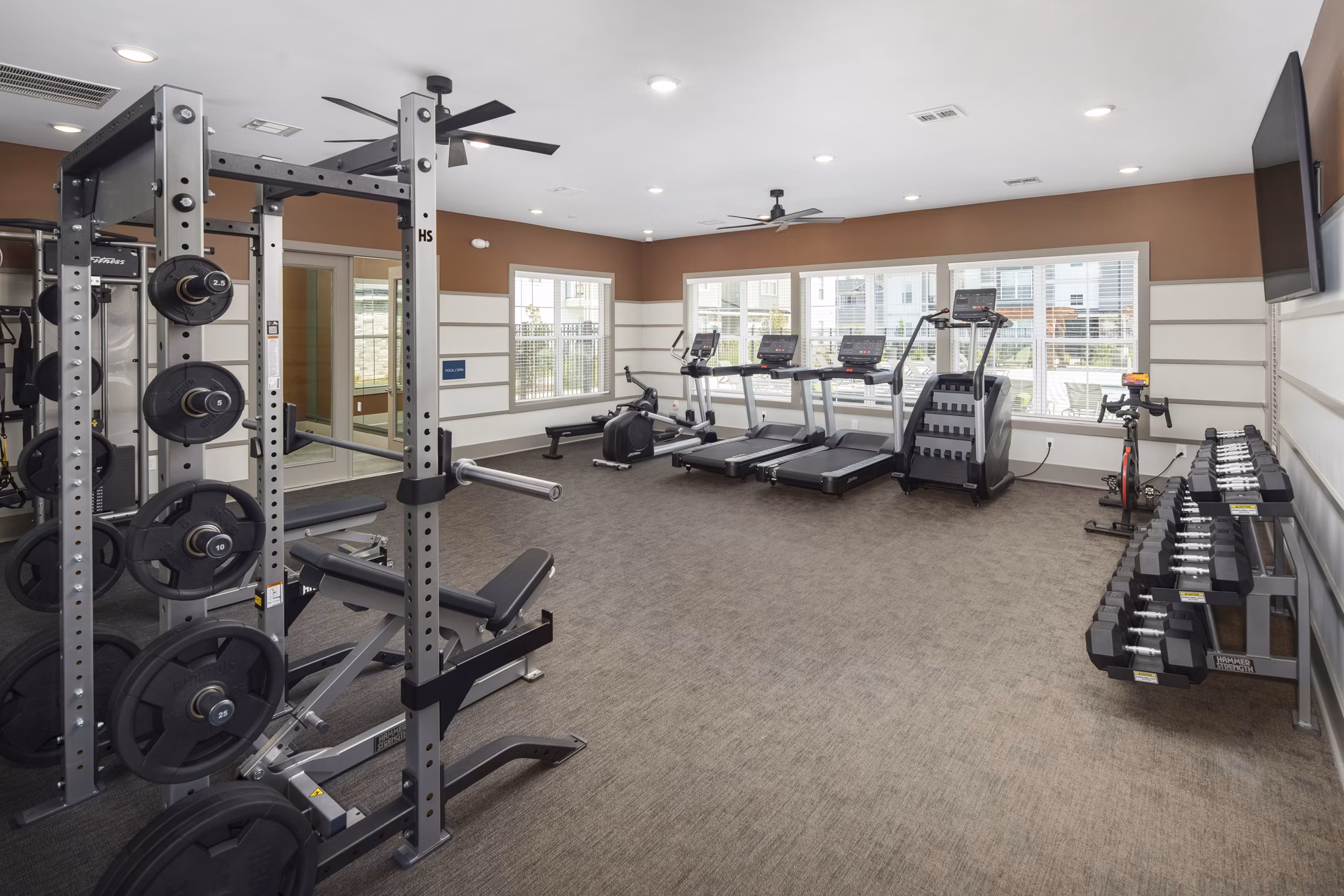 Fitness center featuring modern equipment at The Mill at White House Apartments