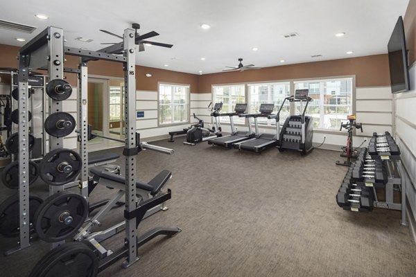 Fitness center featuring modern equipment at The Mill at White House Apartments