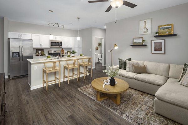 Living room with plush seating and elegant decor at The Mill at White House Apartments, offering luxurious comfort in a stylish setting