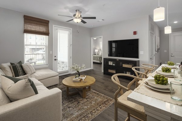 Stylish living room with modern decor at The Mill at White House Apartments, a luxury Greystar property