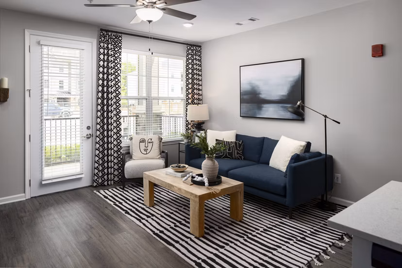 Spacious living room with modern decor in The Mill at White House Apartments