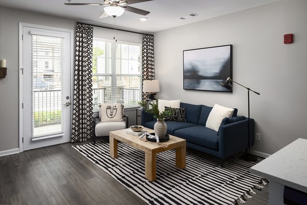 Spacious living room with modern decor in The Mill at White House Apartments