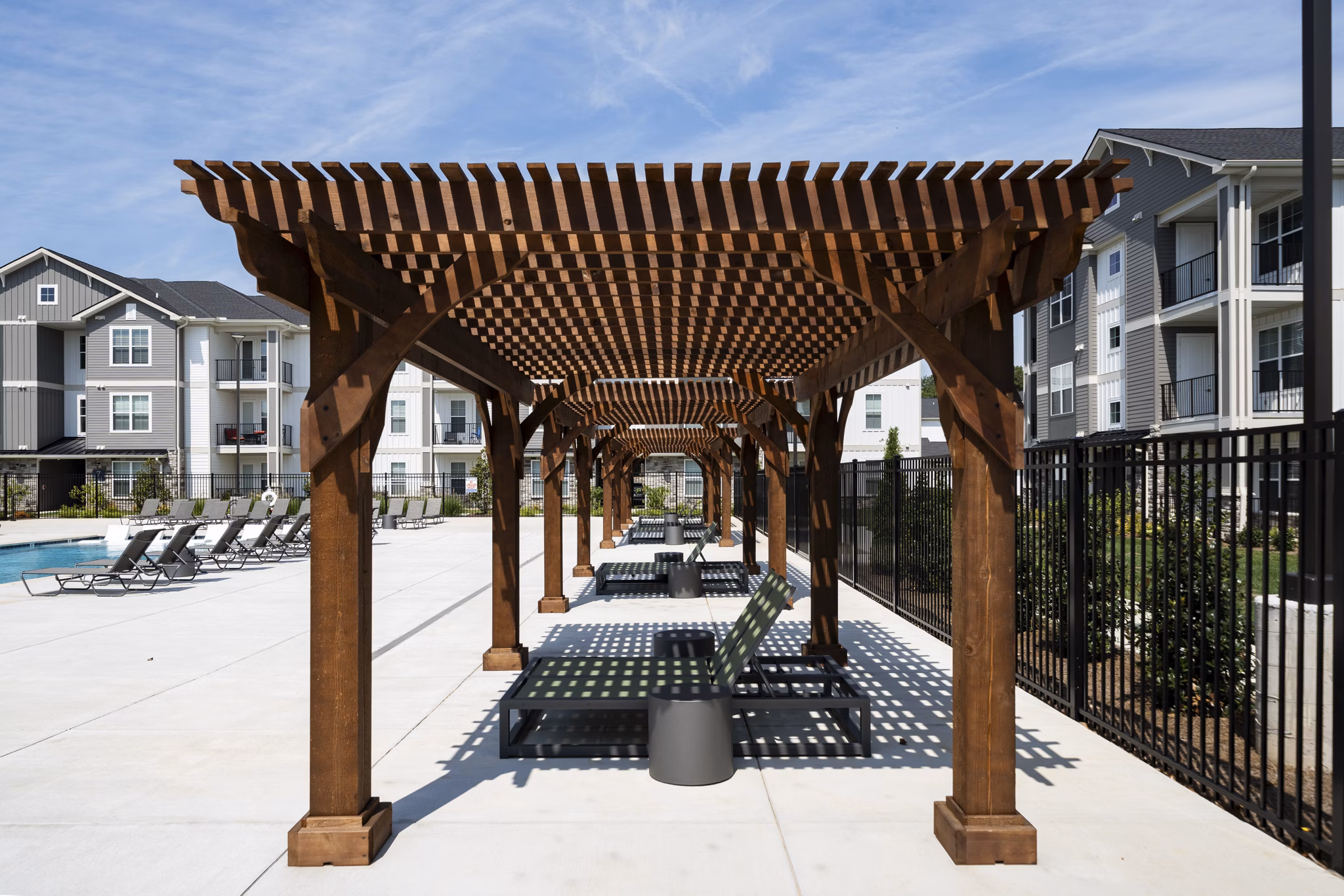 Patio with cozy seating and lush greenery at The Mill at White House Apartments, perfect for relaxing