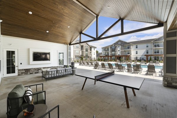 Patio with modern seating and garden views at The Mill at White House Apartments