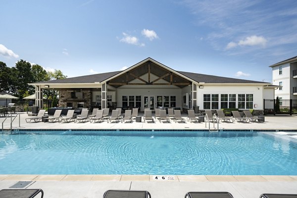 Resort-style pool with lounge chairs at The Mill at White House Apartments