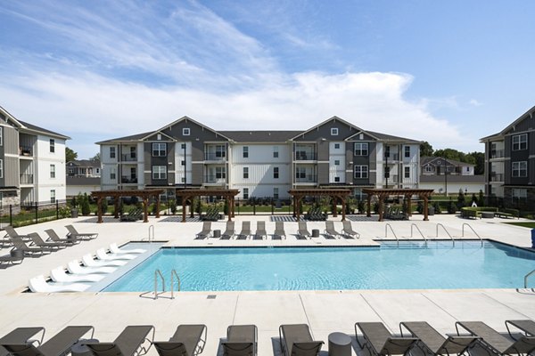 Resort-style pool with lounge chairs at The Mill luxury apartments in White House