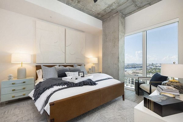Contemporary bedroom with modern furnishings at The MAV Apartments in Houston