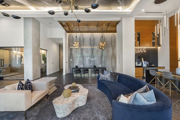 Clubhouse interior featuring modern furnishings and communal spaces at The MAV Apartments
