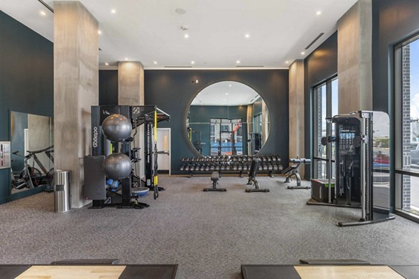 State-of-the-art fitness center with modern equipment at The MAV Apartments