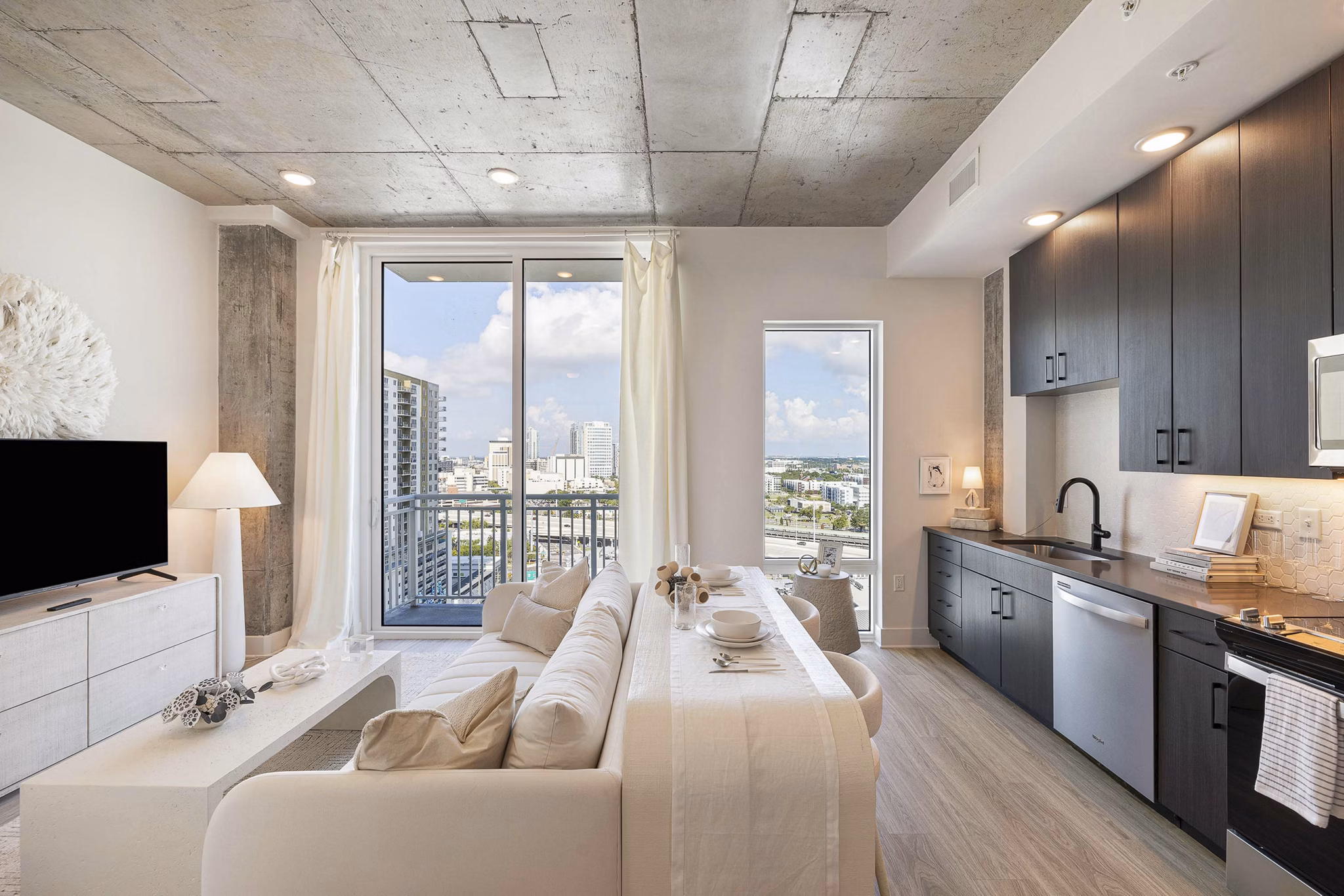 Modern kitchen with stainless steel appliances at The MAV Apartments
