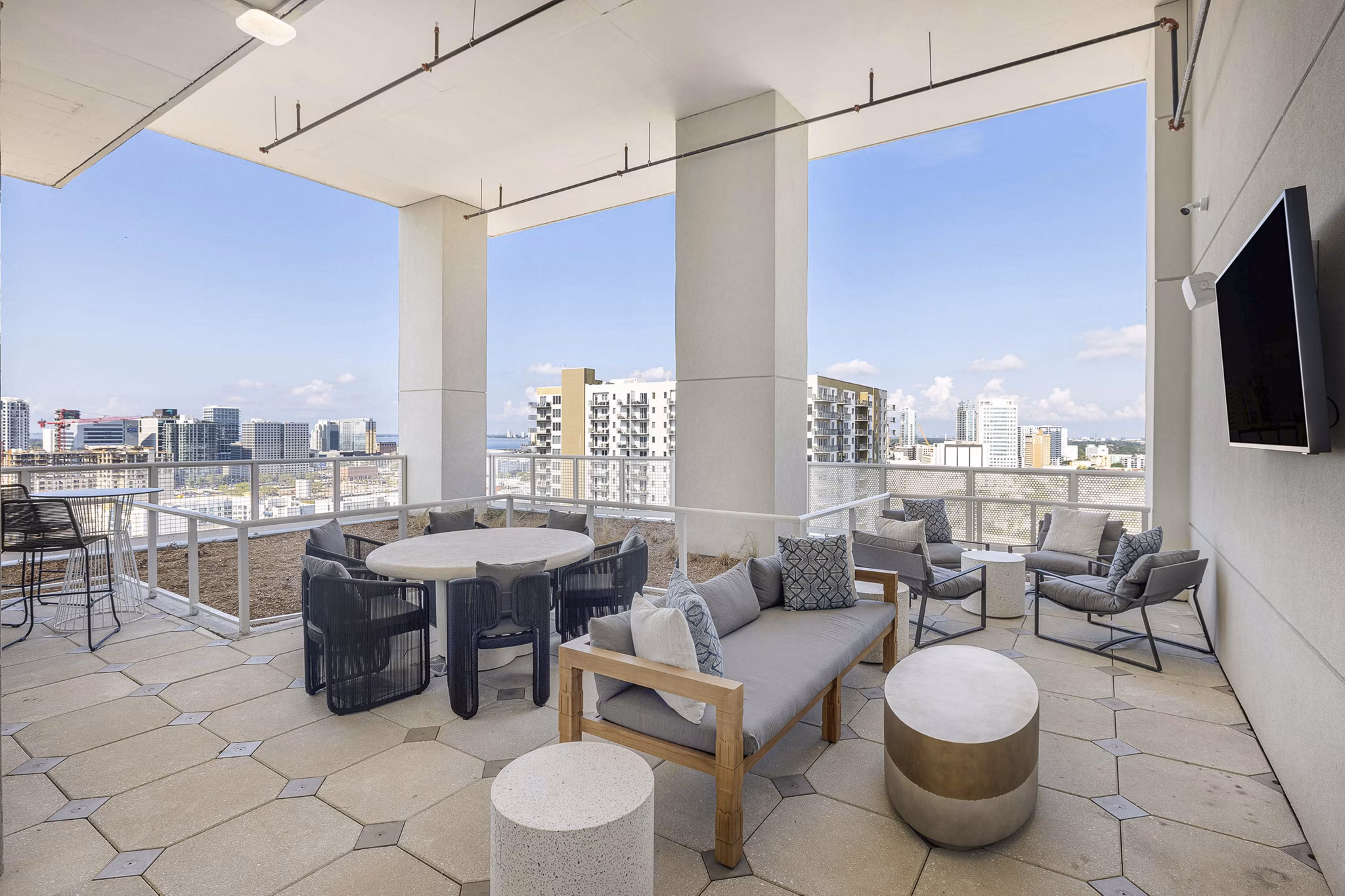 Patio with modern seating and lush greenery at The MAV Apartments, Greystar luxury community in an urban setting