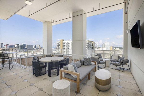 Patio with modern seating and lush greenery at The MAV Apartments, Greystar luxury community in an urban setting
