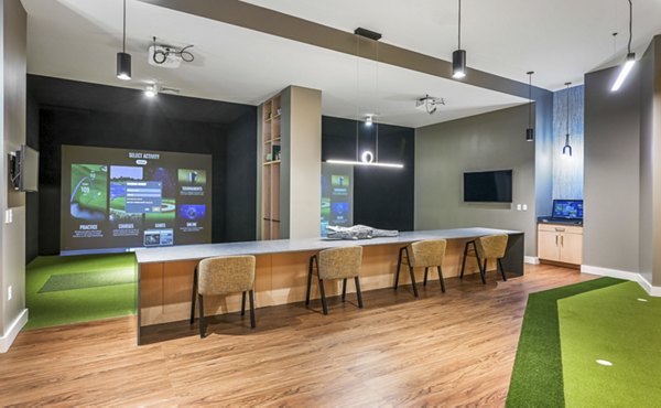 Virtual driving range at Anthem Everett Apartments offering golf simulation and practice facilities for residents