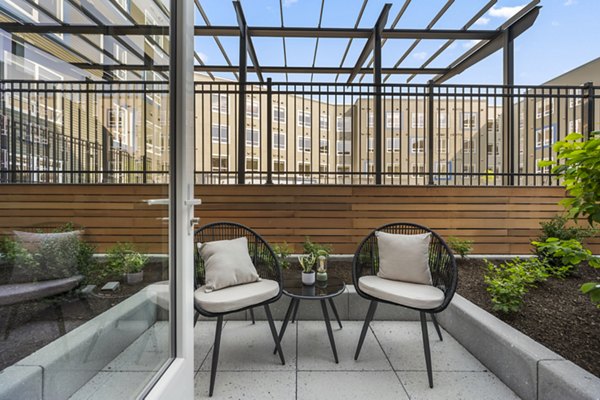 Relaxing patio with modern furniture at Anthem Everett Apartments, perfect for enjoying the outdoors