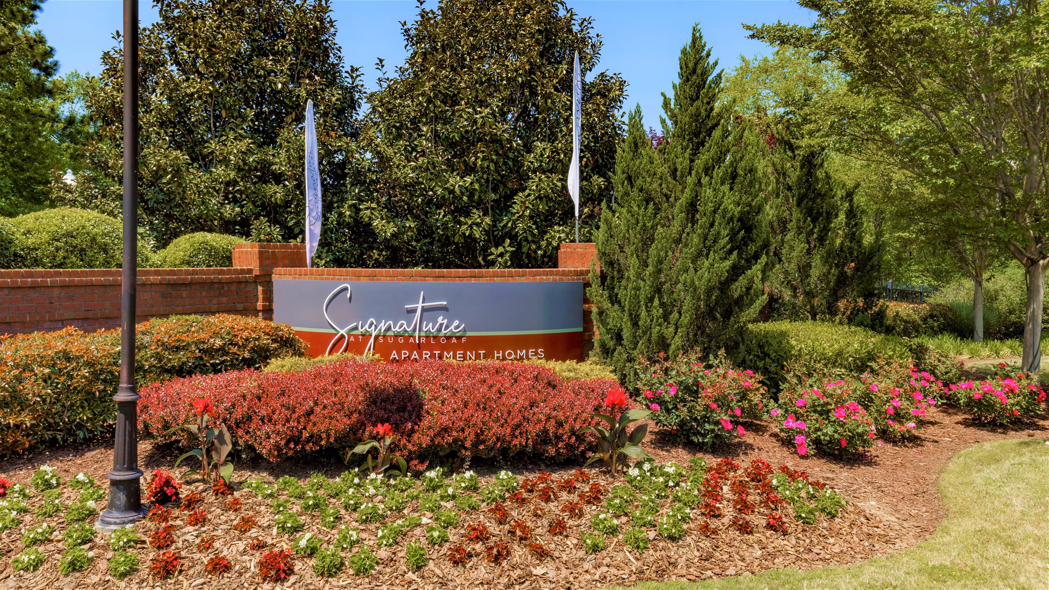 Signage at Signature at Sugarloaf Apartments showcasing modern design in vibrant Duluth community