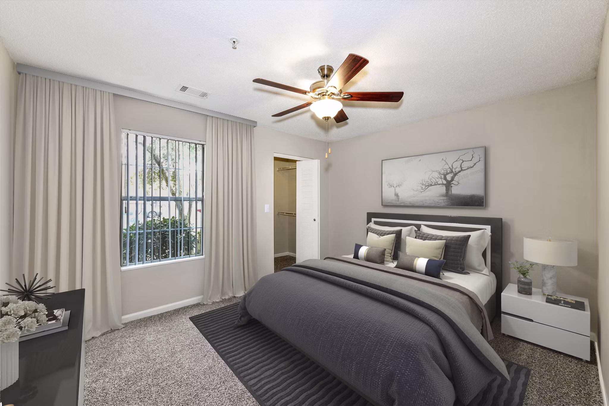 Bedroom with elegant decor, plush bedding, and ample natural light at Signature at Sugarloaf Apartments