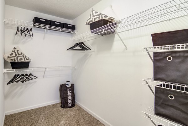 Walk-in closet with organized shelving in Signature at Sugarloaf Apartments