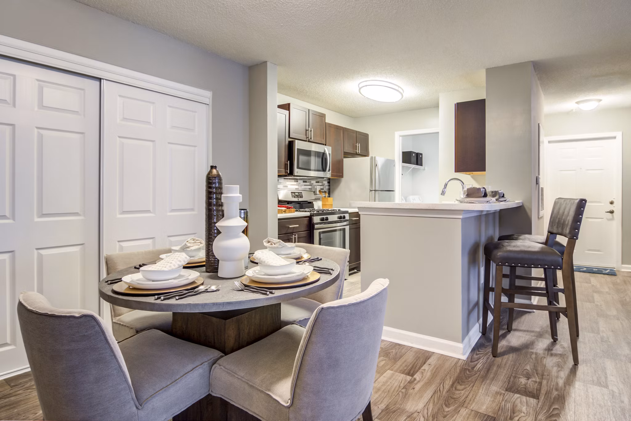 Dining area with elegant furnishings and modern lighting at Signature at Sugarloaf Apartments