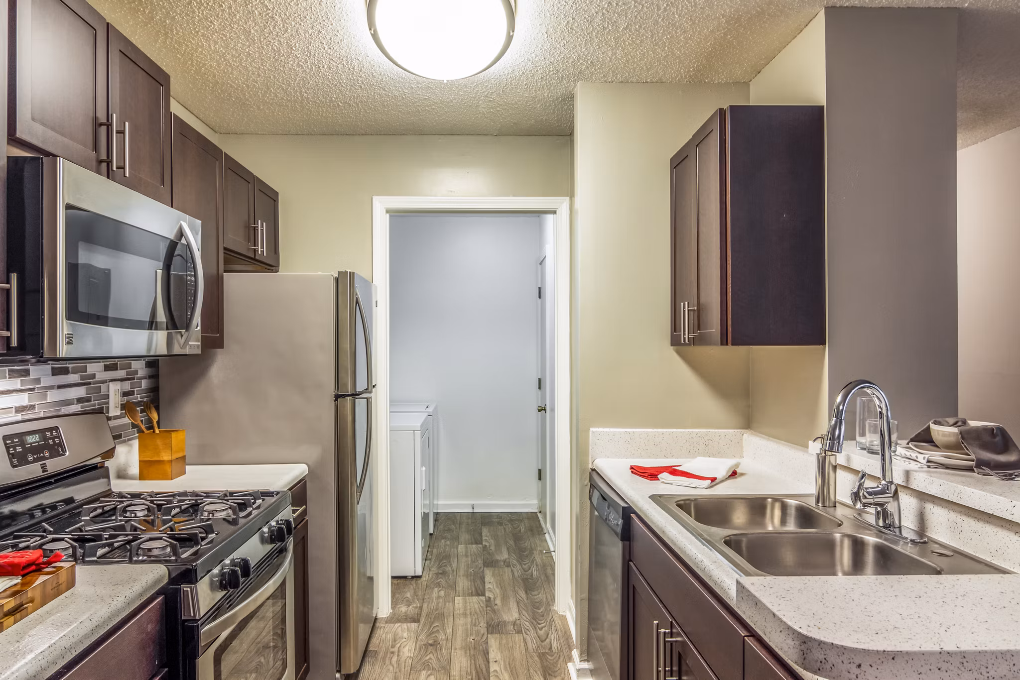 Modern kitchen with stainless steel appliances at Signature at Sugarloaf Apartments