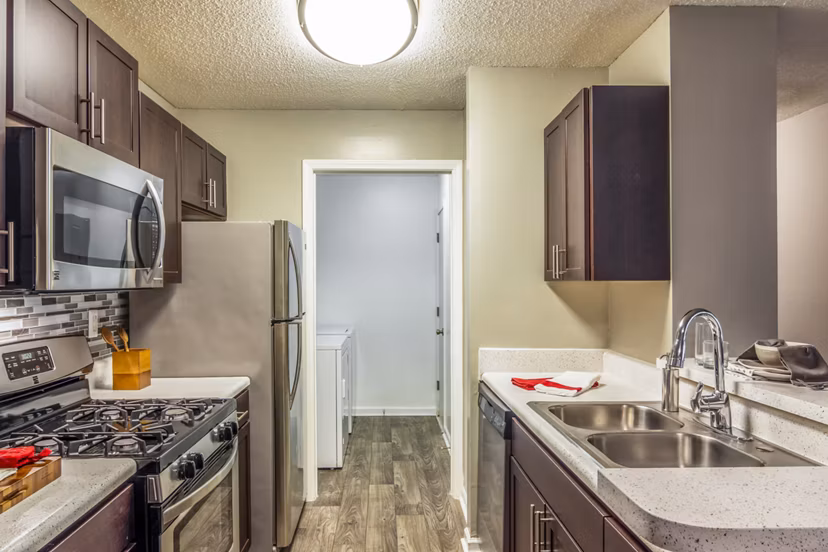Modern kitchen with stainless steel appliances at Signature at Sugarloaf Apartments