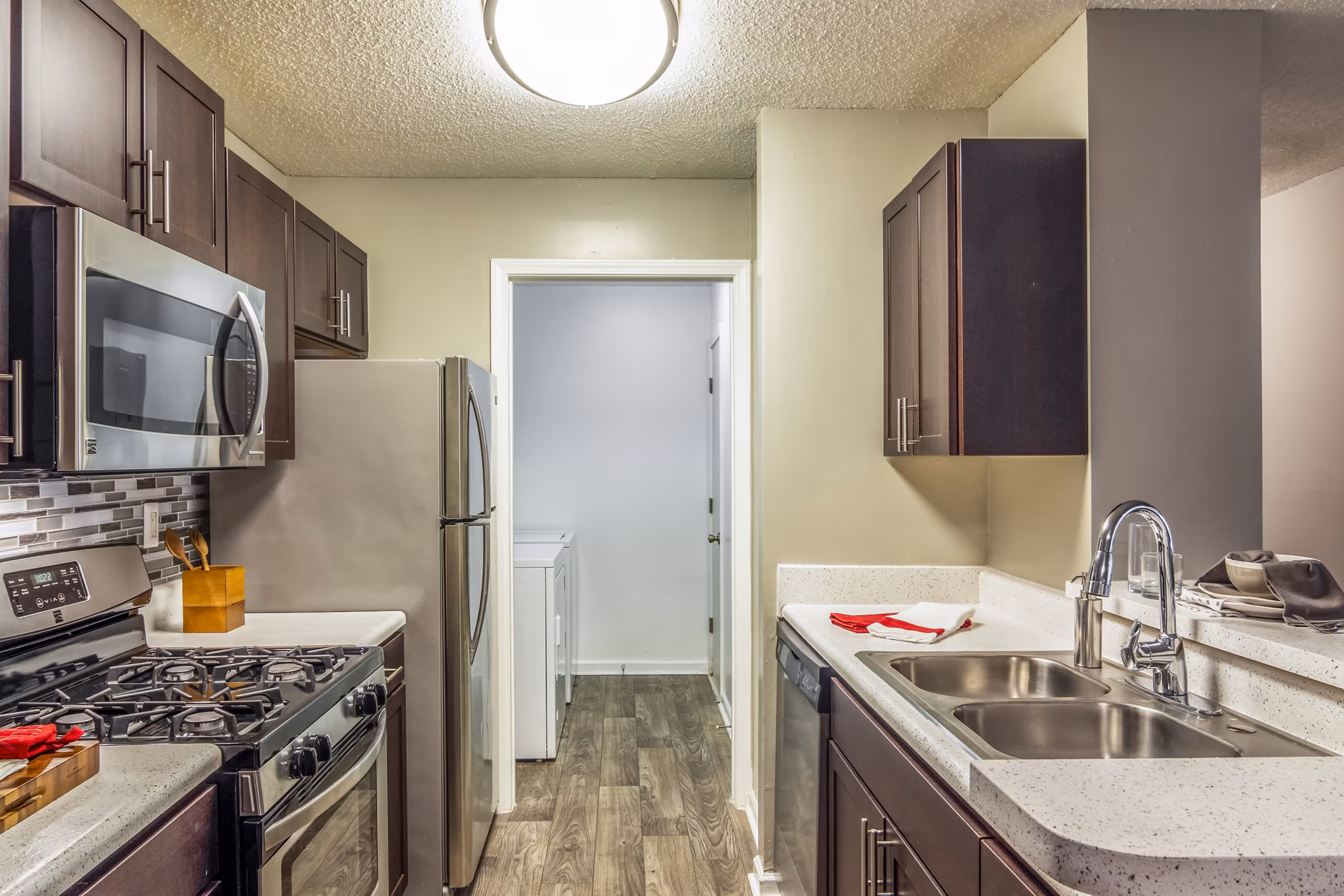 Modern kitchen with stainless steel appliances at Signature at Sugarloaf Apartments