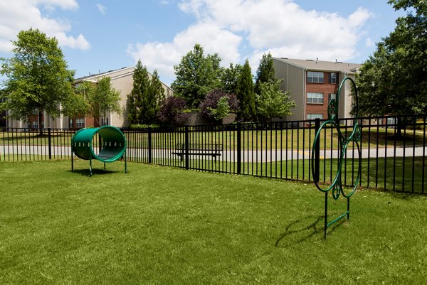 Dog park with agility equipment at Signature at Sugarloaf Apartments, featuring open play areas and pet-friendly amenities