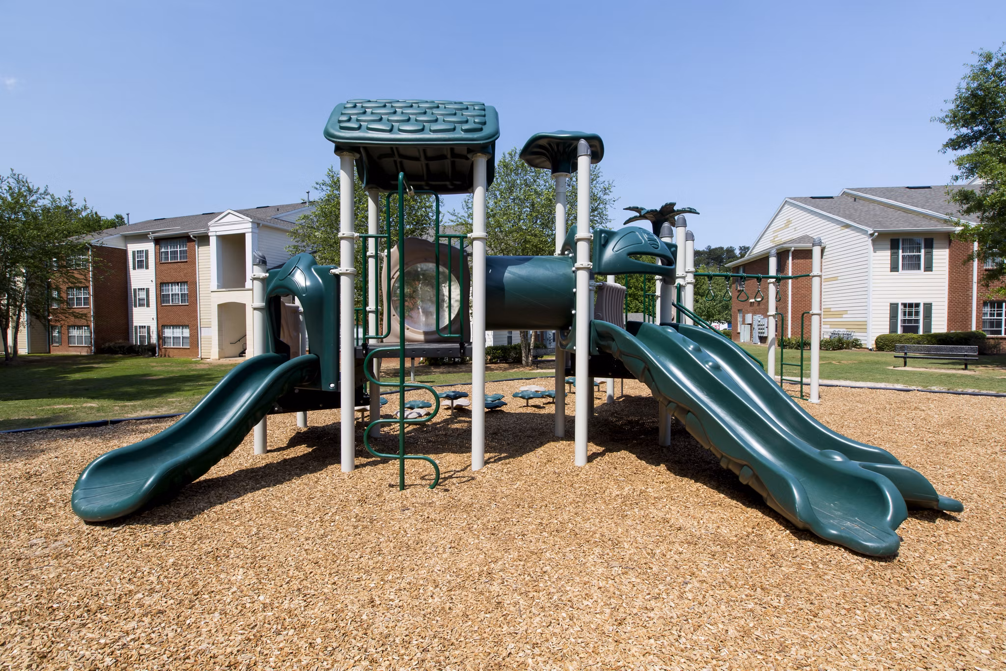 Colorful playground with slides and swings at Signature at Sugarloaf Apartments, perfect for families and outdoor fun