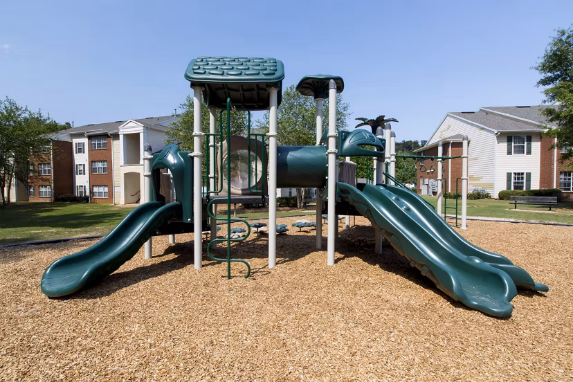 Colorful playground with slides and swings at Signature at Sugarloaf Apartments, perfect for families and outdoor fun
