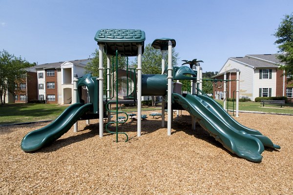 Colorful playground with slides and swings at Signature at Sugarloaf Apartments, perfect for families and outdoor fun