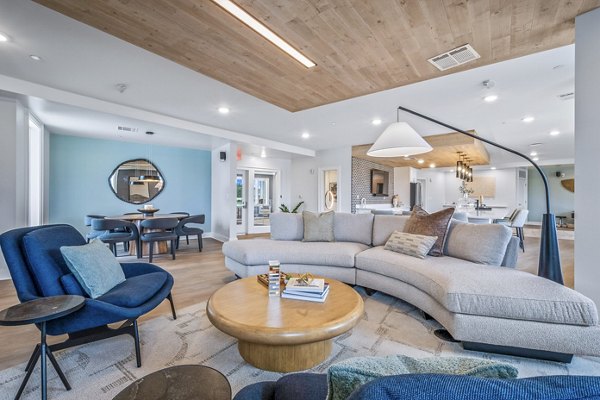Clubhouse featuring modern design and seating areas at Attain at Bradford Creek Apartments