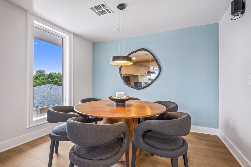 Clubhouse with modern furnishings and natural light at Attain at Bradford Creek Apartments