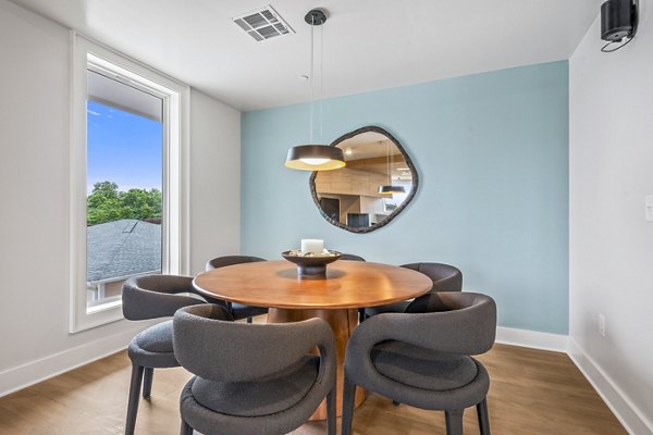 Clubhouse with modern furnishings and natural light at Attain at Bradford Creek Apartments