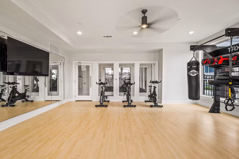 Modern yoga/spin studio with sleek equipment at Attain at Bradford Creek Apartments