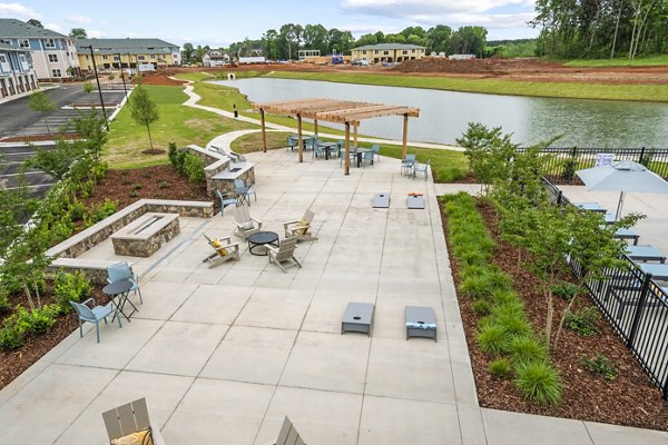 Spacious patio with grilling stations at Attain at Bradford Creek Apartments, ideal for outdoor recreation and social gatherings