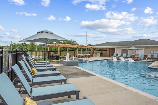 Luxurious pool area at Attain at Bradford Creek Apartments with comfortable lounging spaces