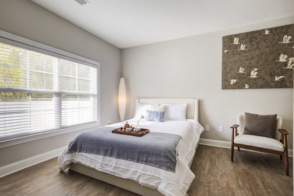 Cozy bedroom with modern furnishings in Parq 170 Apartments, offering luxury living at Greystar's premier community