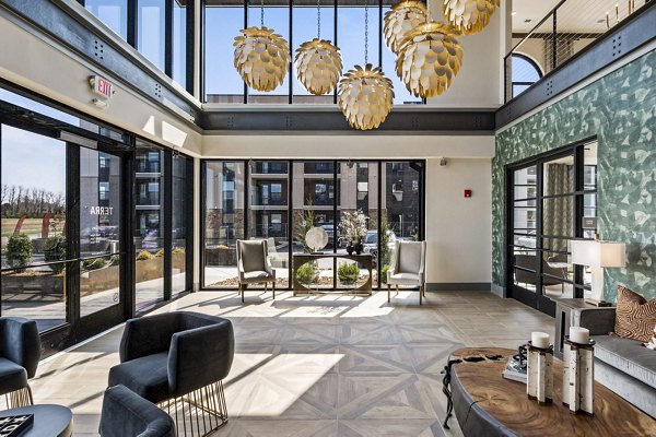 Clubhouse featuring modern seating and a fireplace at The Terra Apartment Homes, showcasing luxury community living spaces