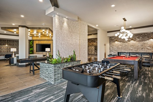 Clubhouse game room featuring billiards and modern decor at The Terra Apartment Homes