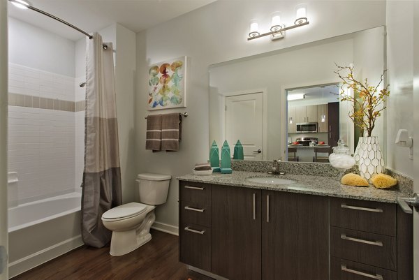Bathroom featuring modern fixtures and spacious shower at Tapestry Largo Station Apartments