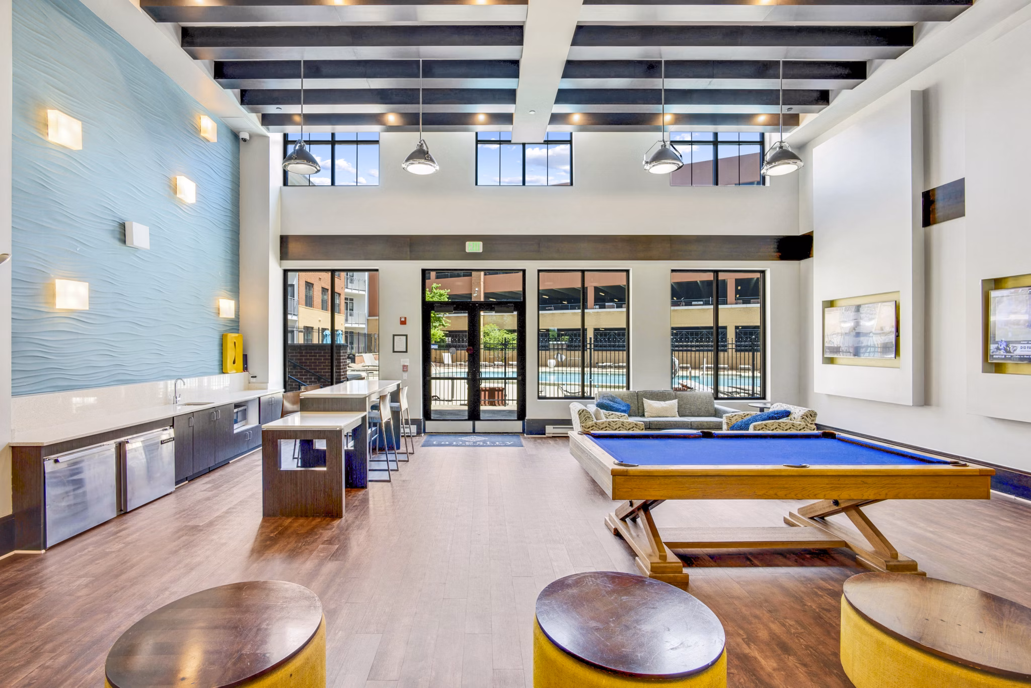 Clubhouse game room with pool table and modern decor at Beckon Apartments
