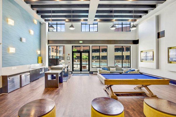 Clubhouse game room with pool table and modern decor at Beckon Apartments