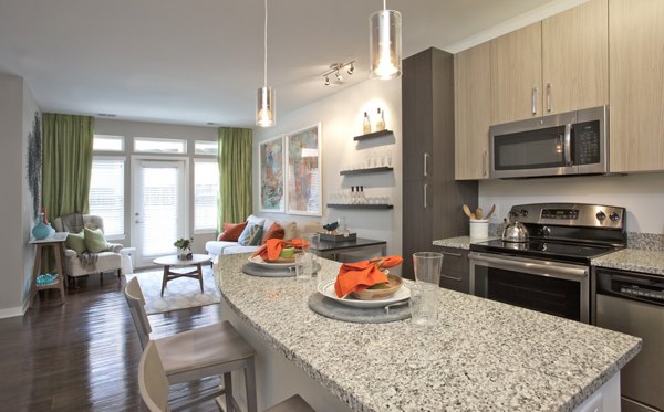 Modern kitchen with stainless steel appliances at Tapestry Largo Station Apartments, offering a luxurious living experience