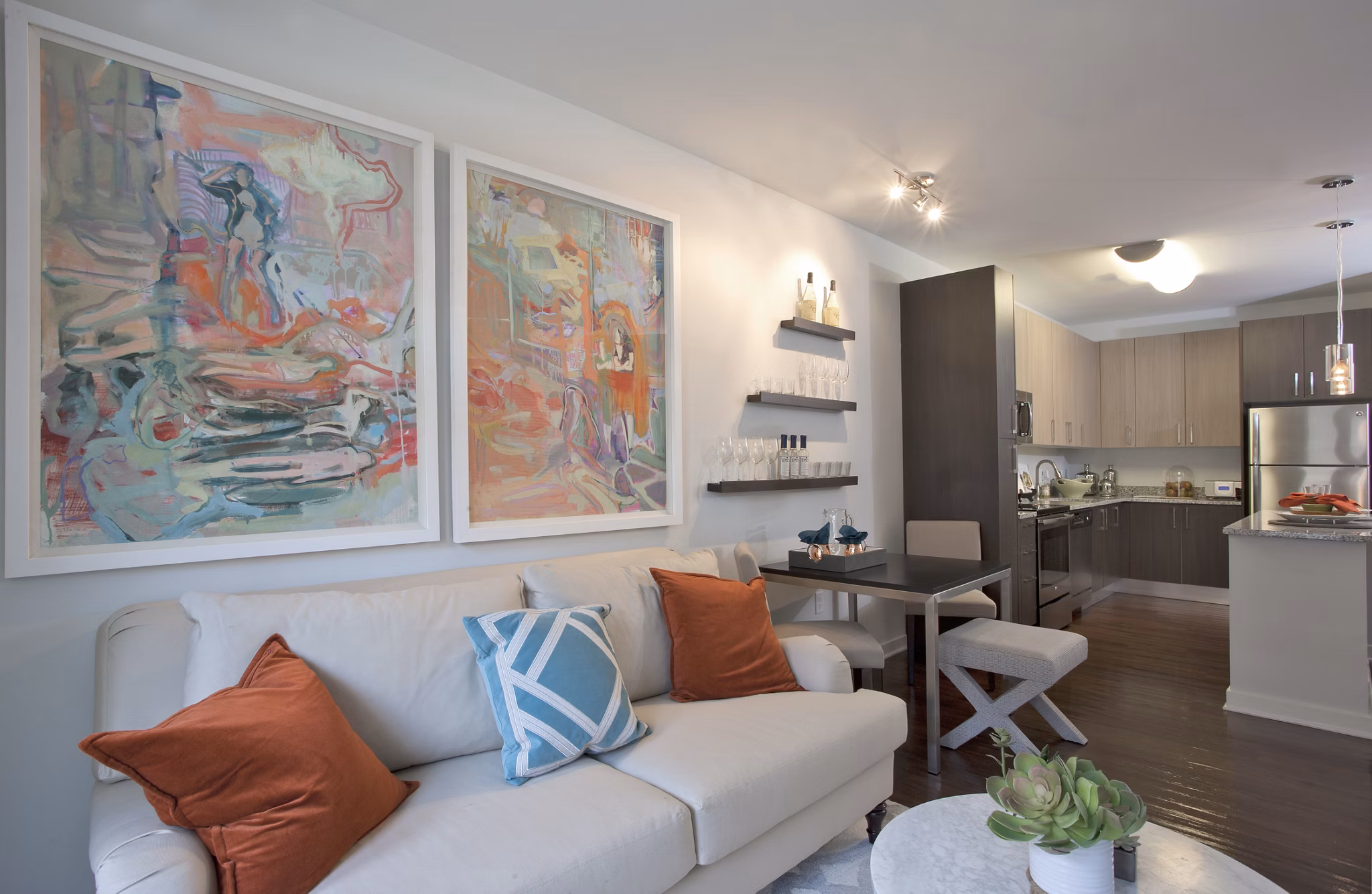 Contemporary living room with plush seating and large windows in Tapestry Largo Station Apartments