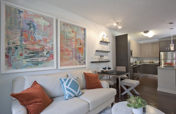 Contemporary living room with plush seating and large windows in Tapestry Largo Station Apartments