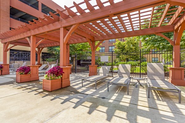 Community pool patio at Tapestry Largo Station Apartments with comfortable lounge seating and modern design