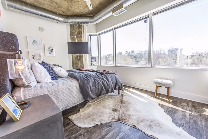 Cozy bedroom with modern furnishings at Elofts Apartments, Greystar luxury apartments in the city center
