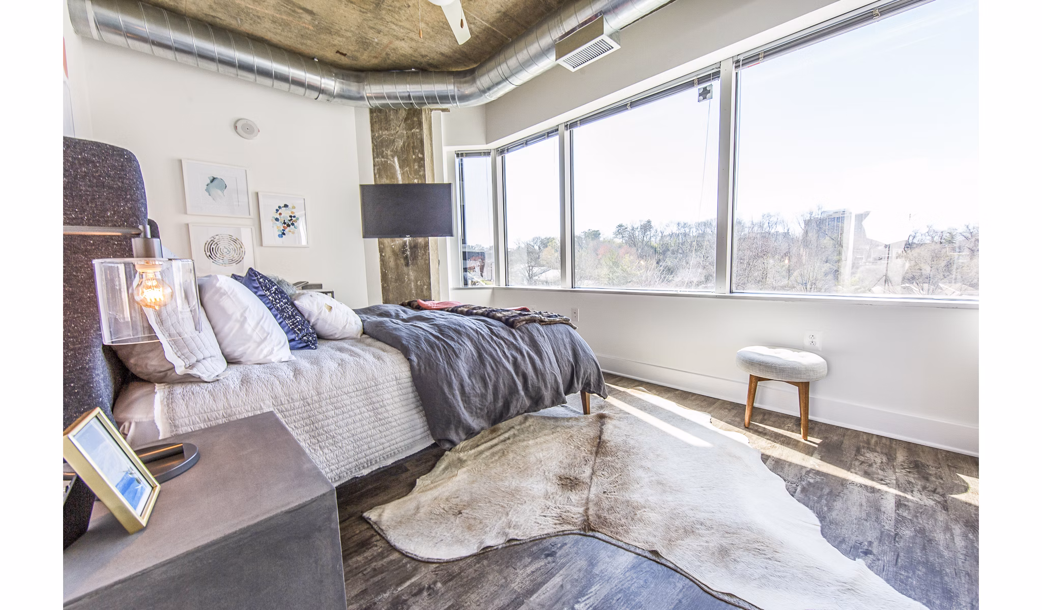 Cozy bedroom with modern furnishings at Elofts Apartments, Greystar luxury apartments in the city center